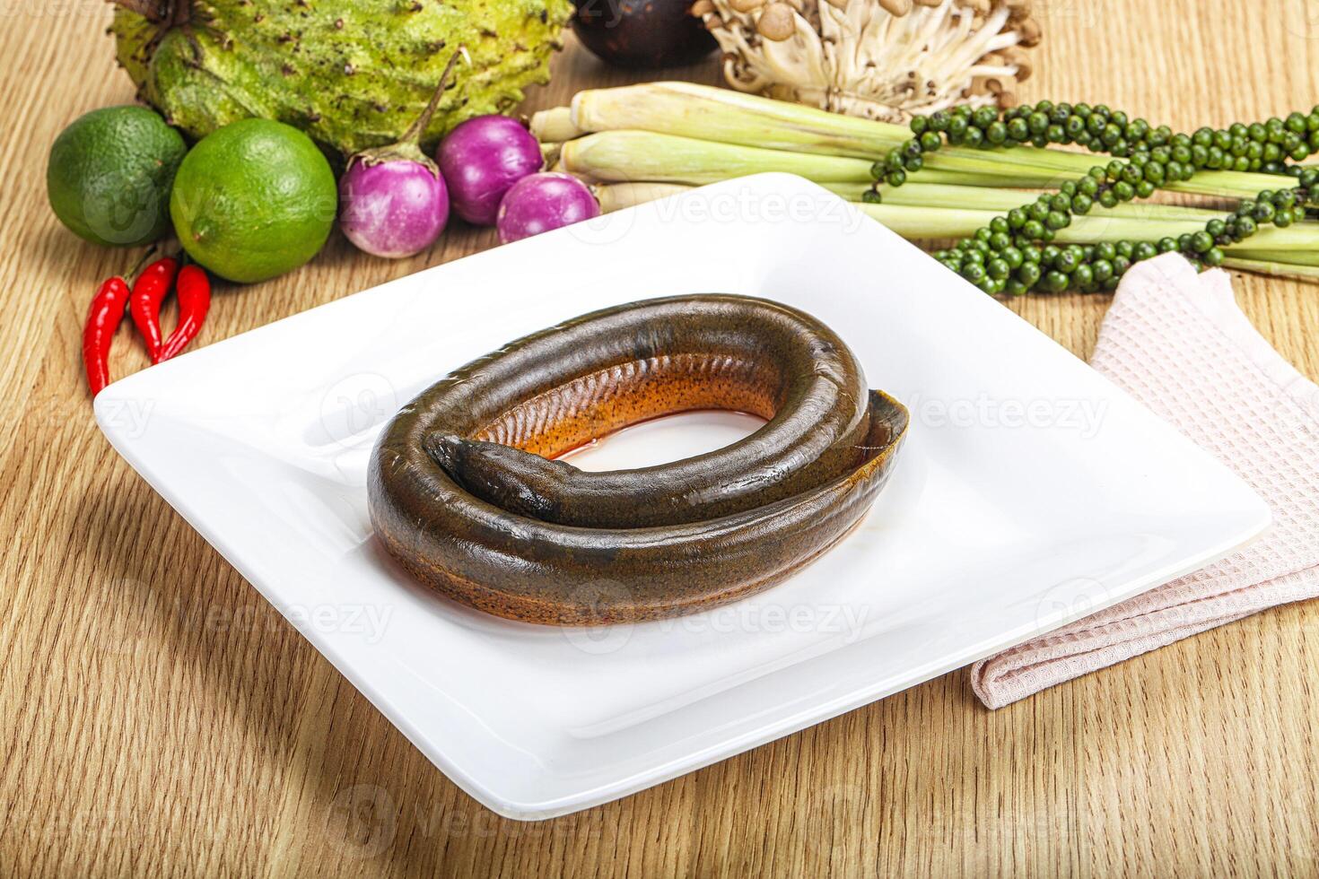 A plate with a fish on it and some vegetables photo