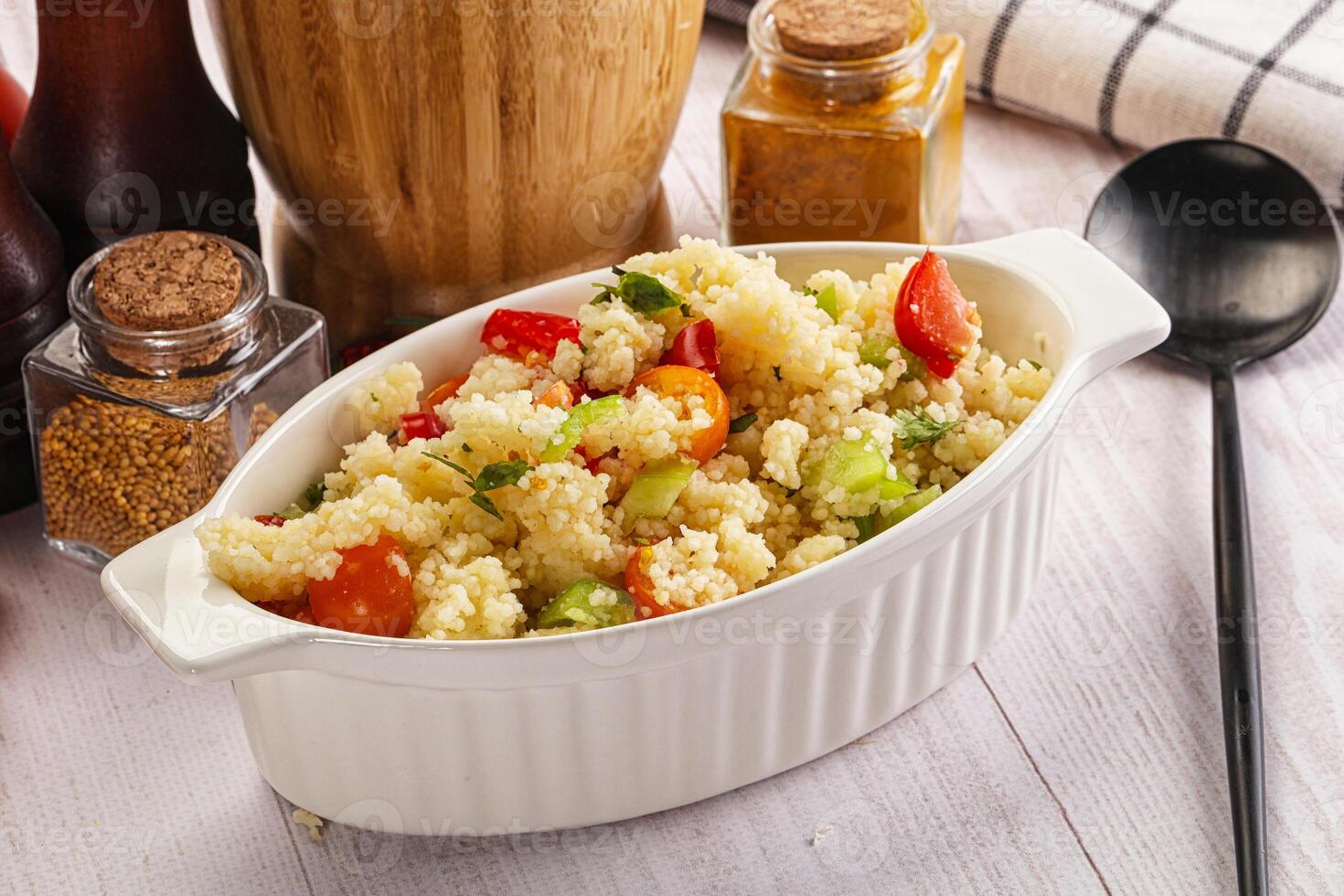 A white bowl filled with a salad on a table photo