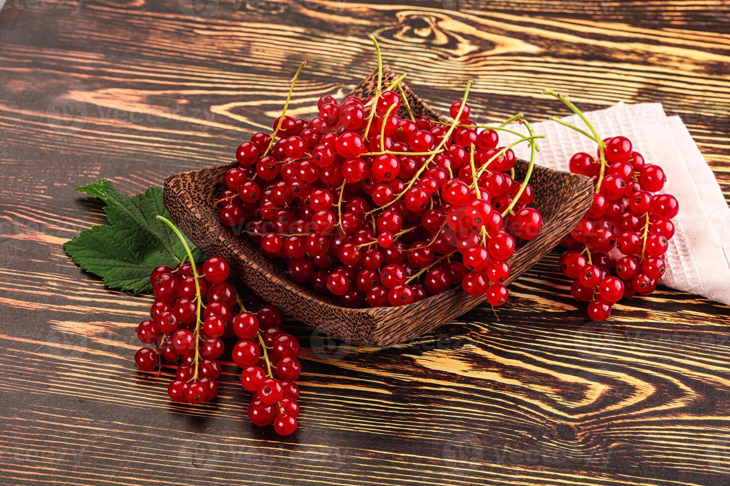 A bowl of red currants on a table photo