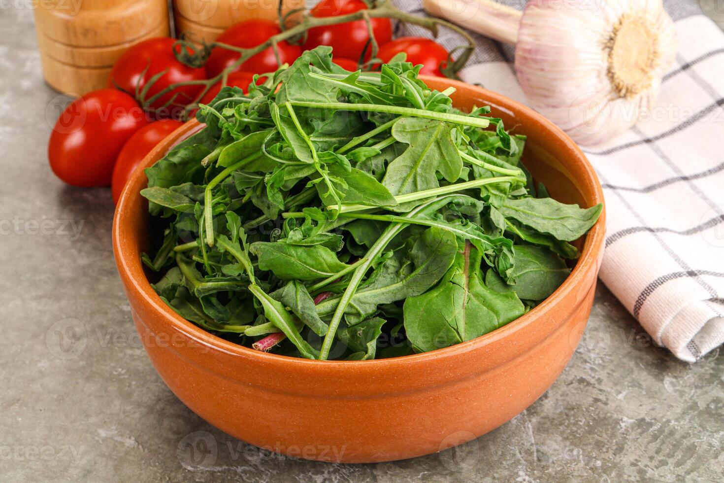 A bowl of spinach with tomatoes and garlic photo