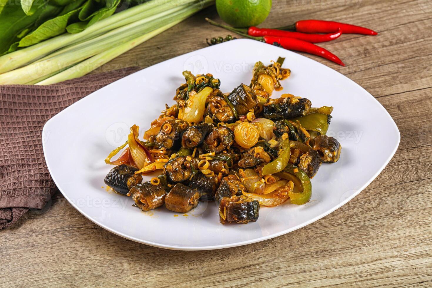 A plate of food on a table with a knife and pepper photo
