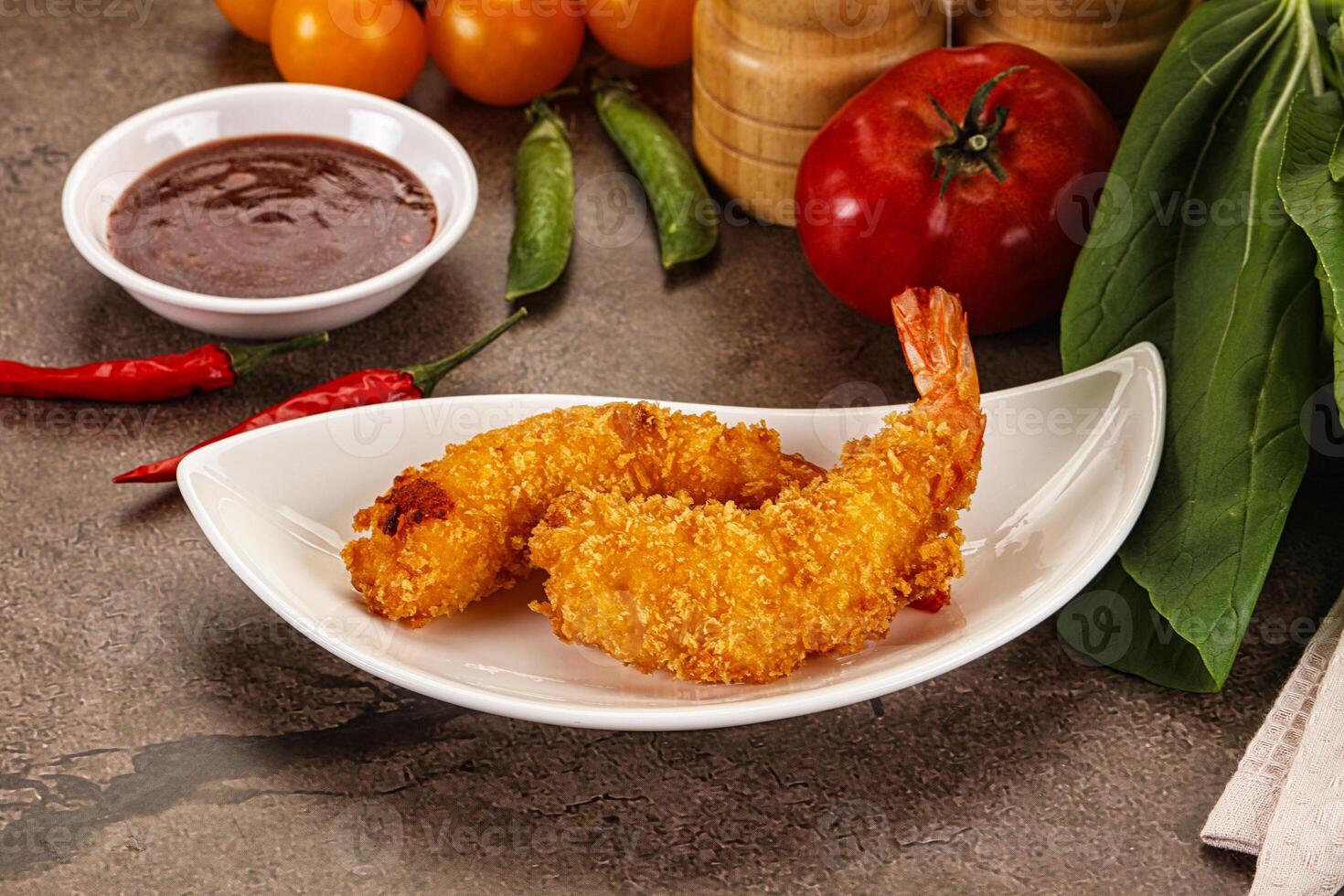 Fried shrimp on a plate with sauce and vegetables photo