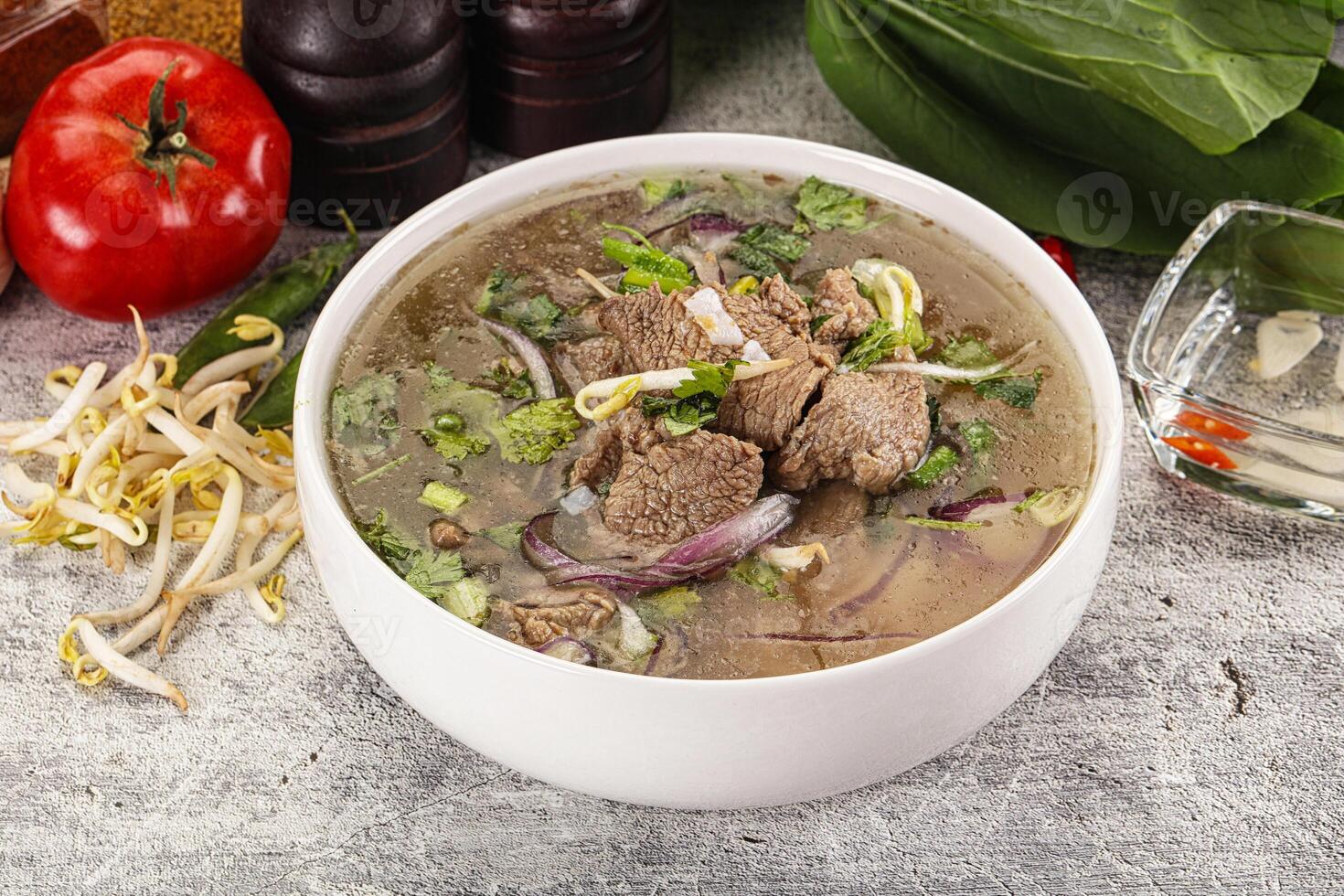 A bowl of soup with meat and vegetables photo