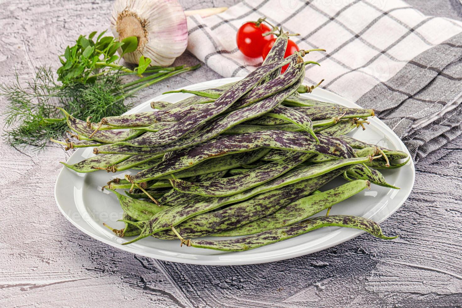 A plate of green beans on a table photo