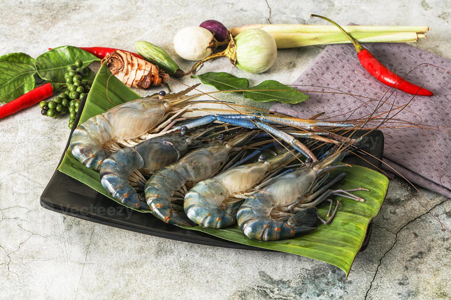Fresh prawns on a plate with herbs and spices photo