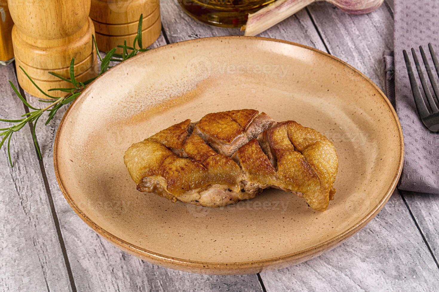 A plate with a piece of meat on it photo