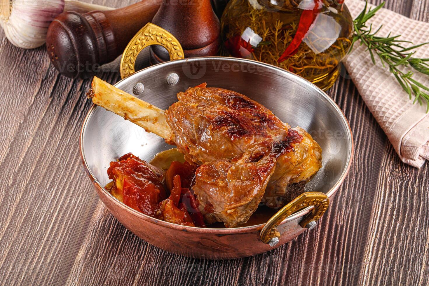A metal bowl filled with meat and vegetables photo
