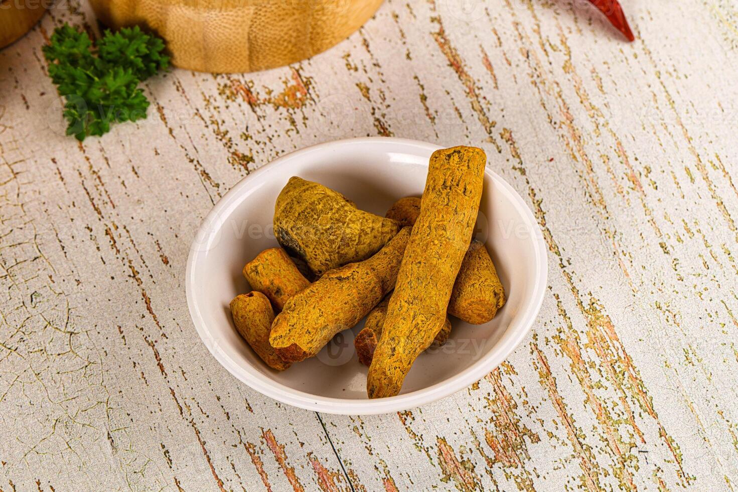 A bowl of food on a table with a pepper and a bowl of food photo