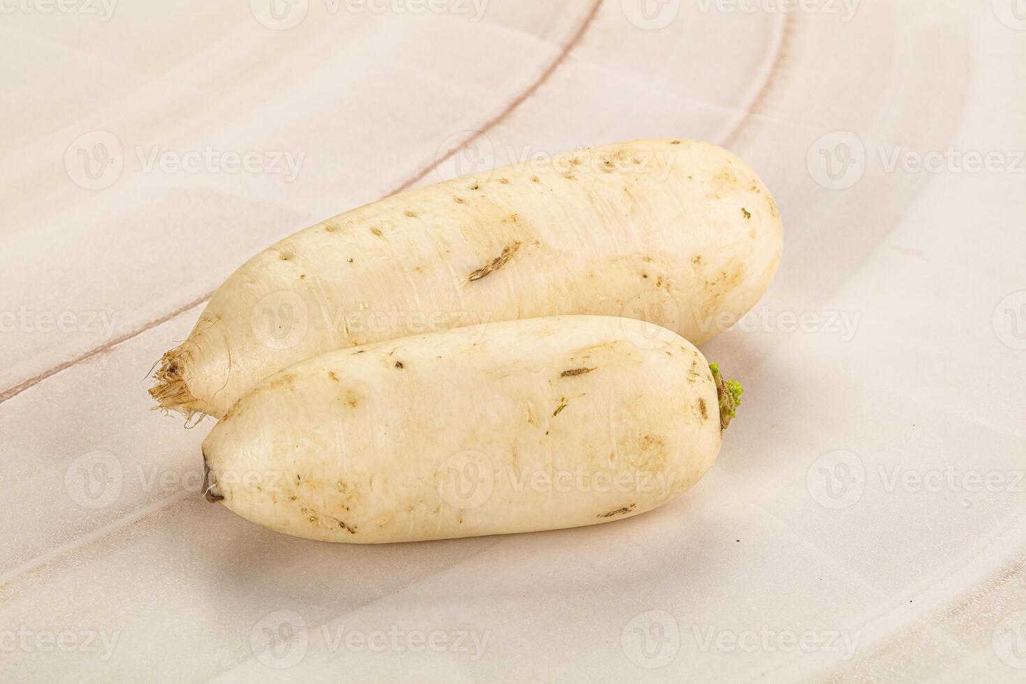 Two white radishes on a white plate photo