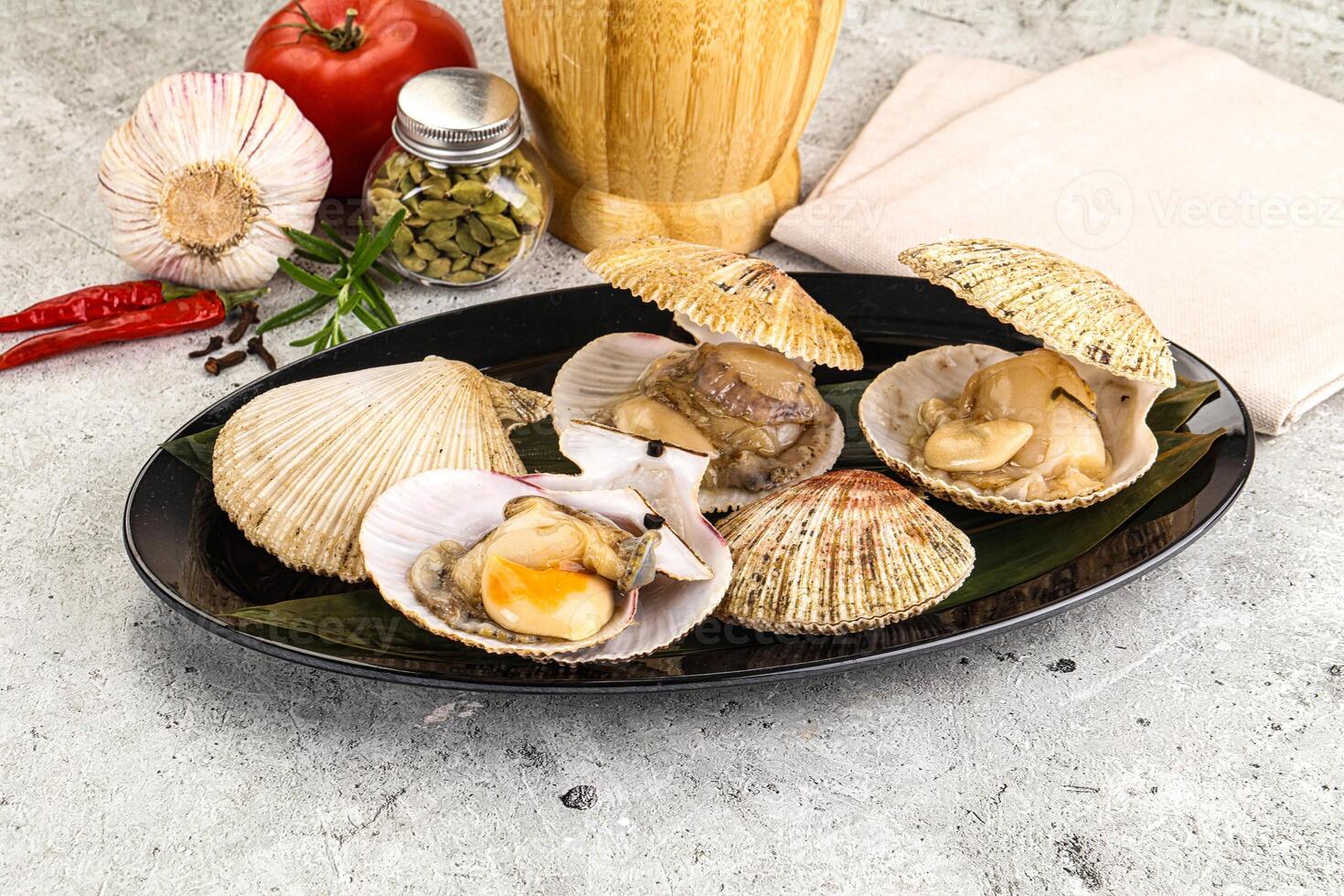 A plate with clams, garlic and tomatoes photo