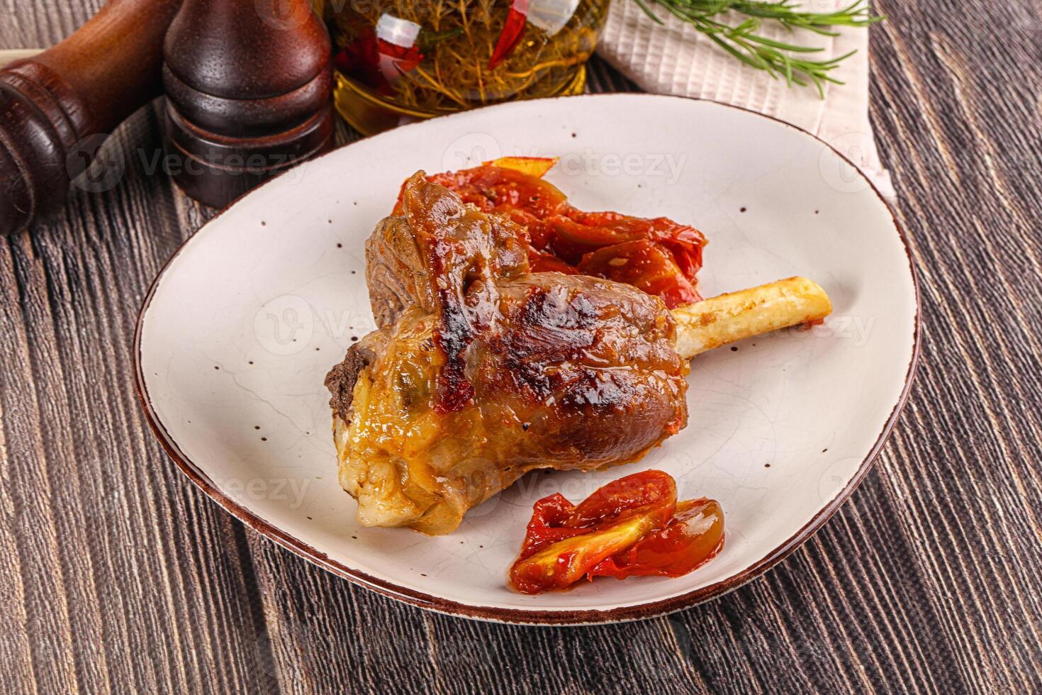 A plate of meat on a wooden table photo