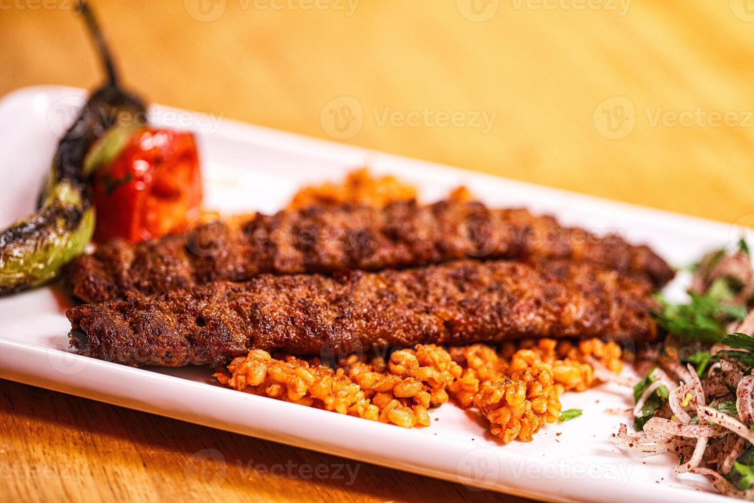 A plate with meat and rice on it photo