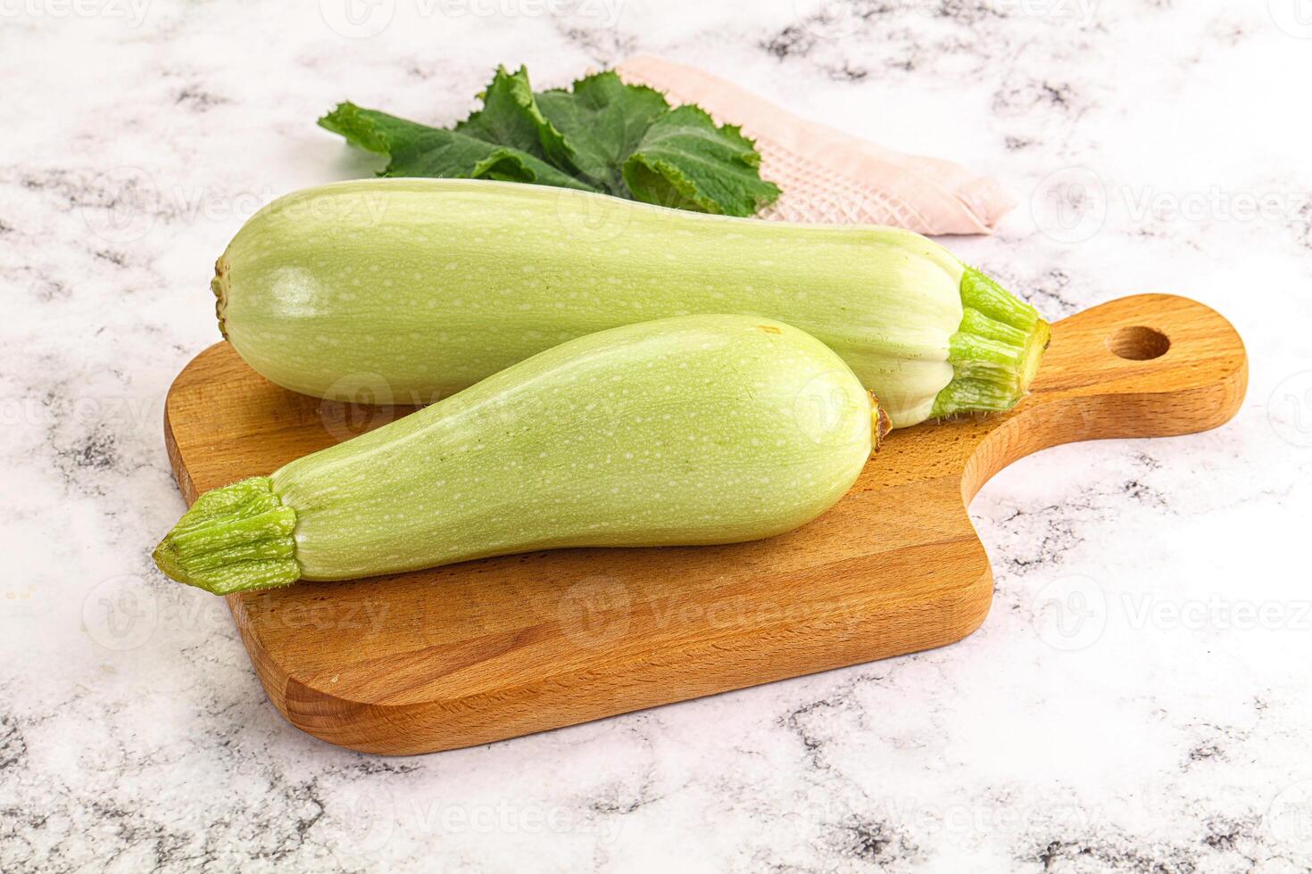 Two green zucchini on a cutting board photo