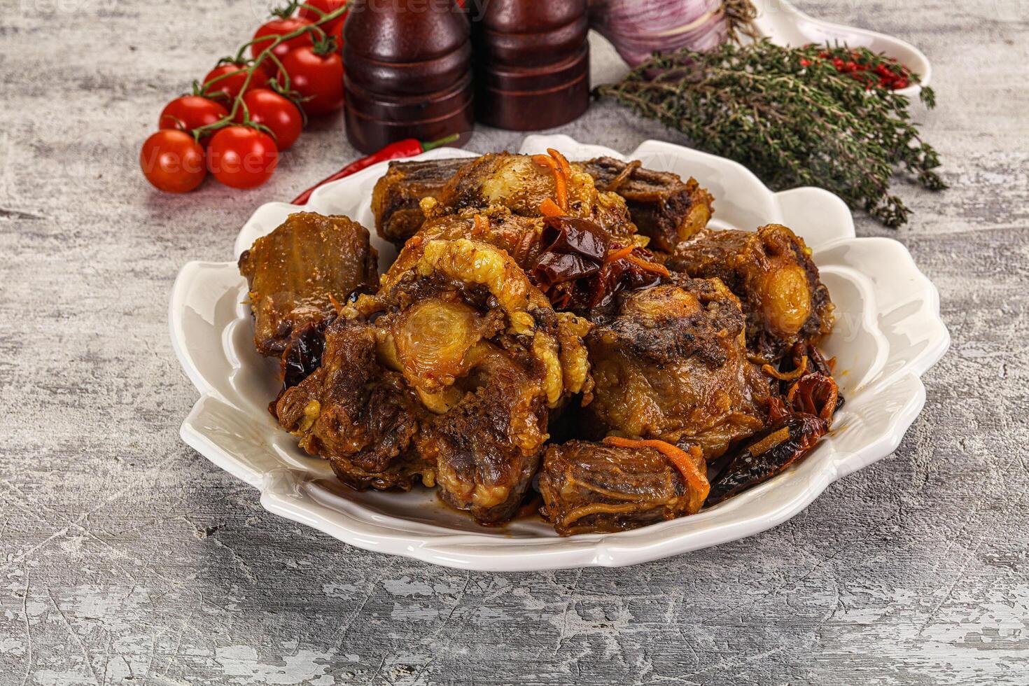 A plate of meat and vegetables on a table photo