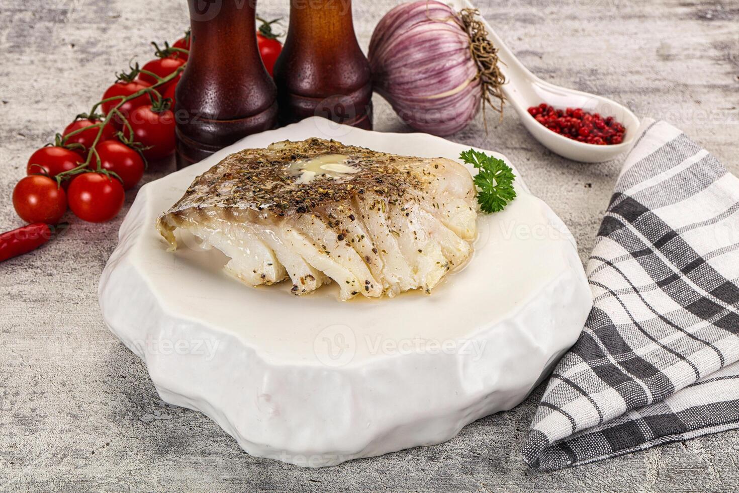 A plate with a piece of fish on it photo