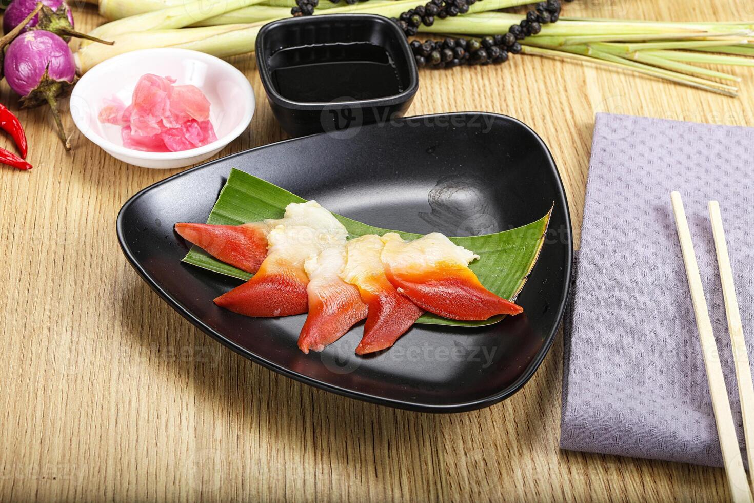 A plate of sushi with chopsticks and a napkin photo