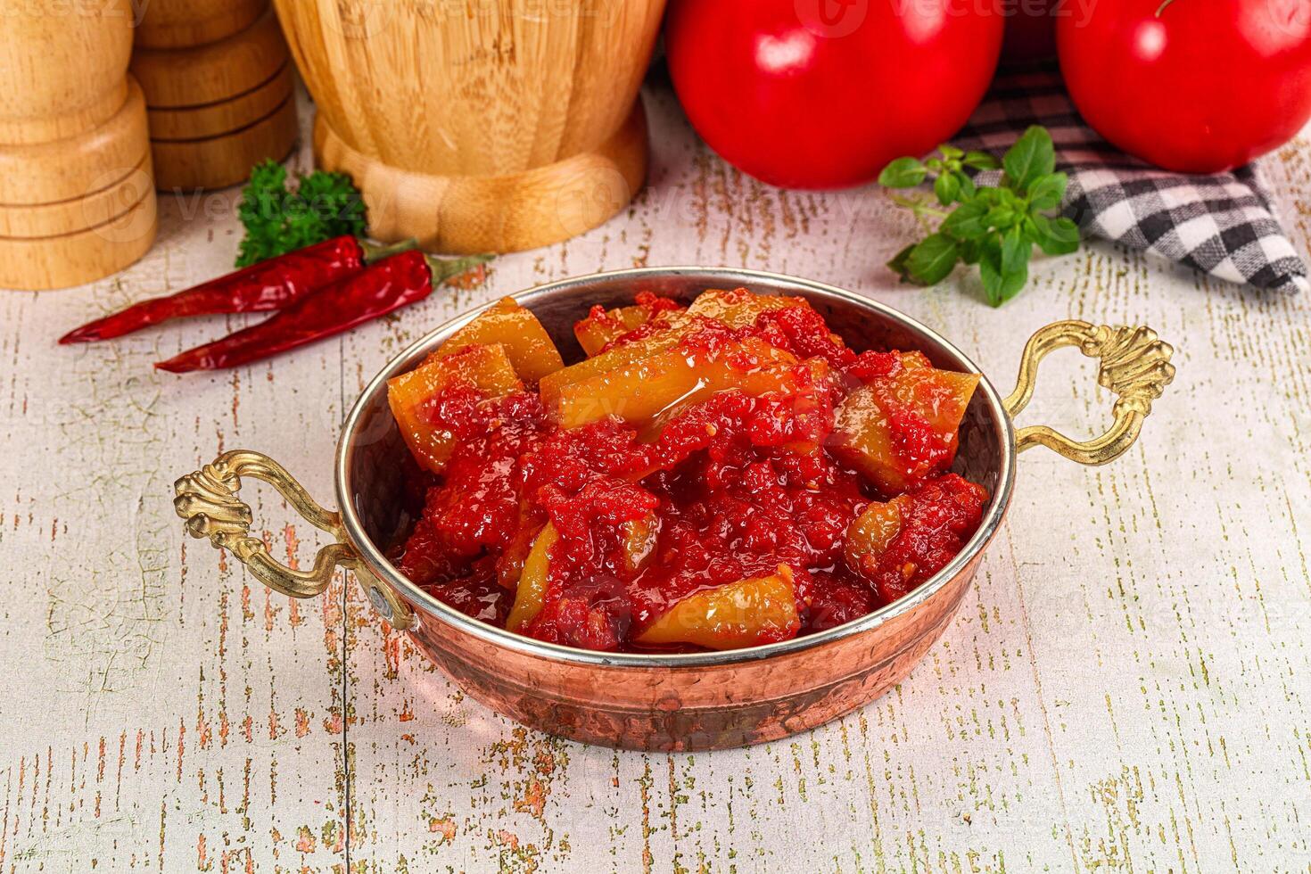 A bowl of tomato sauce with spices and tomatoes photo