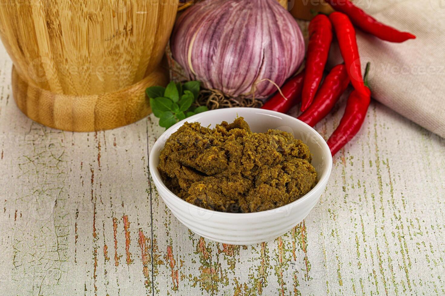 A bowl of spices and a knife on a table photo