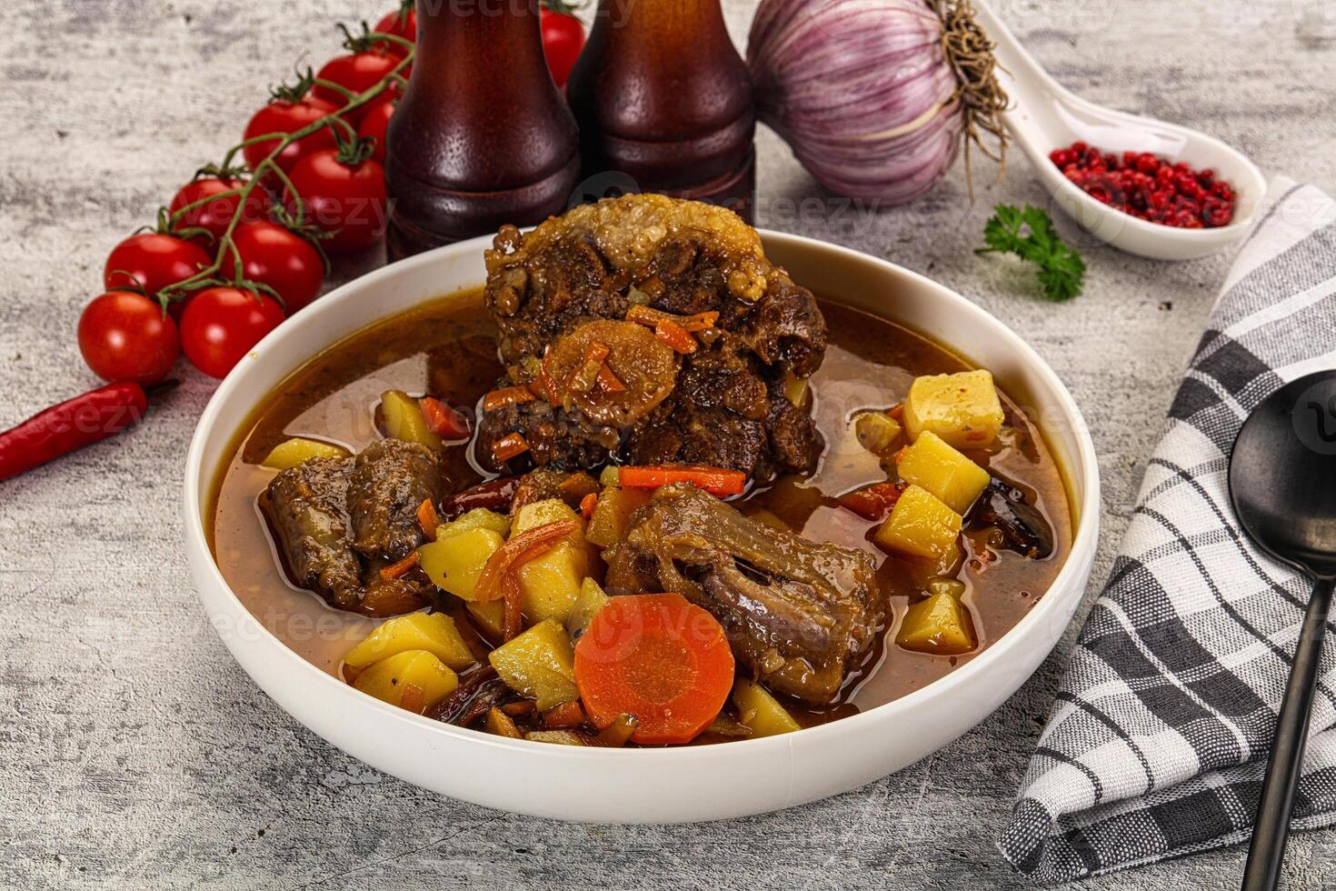 A bowl of stew with vegetables and meat photo