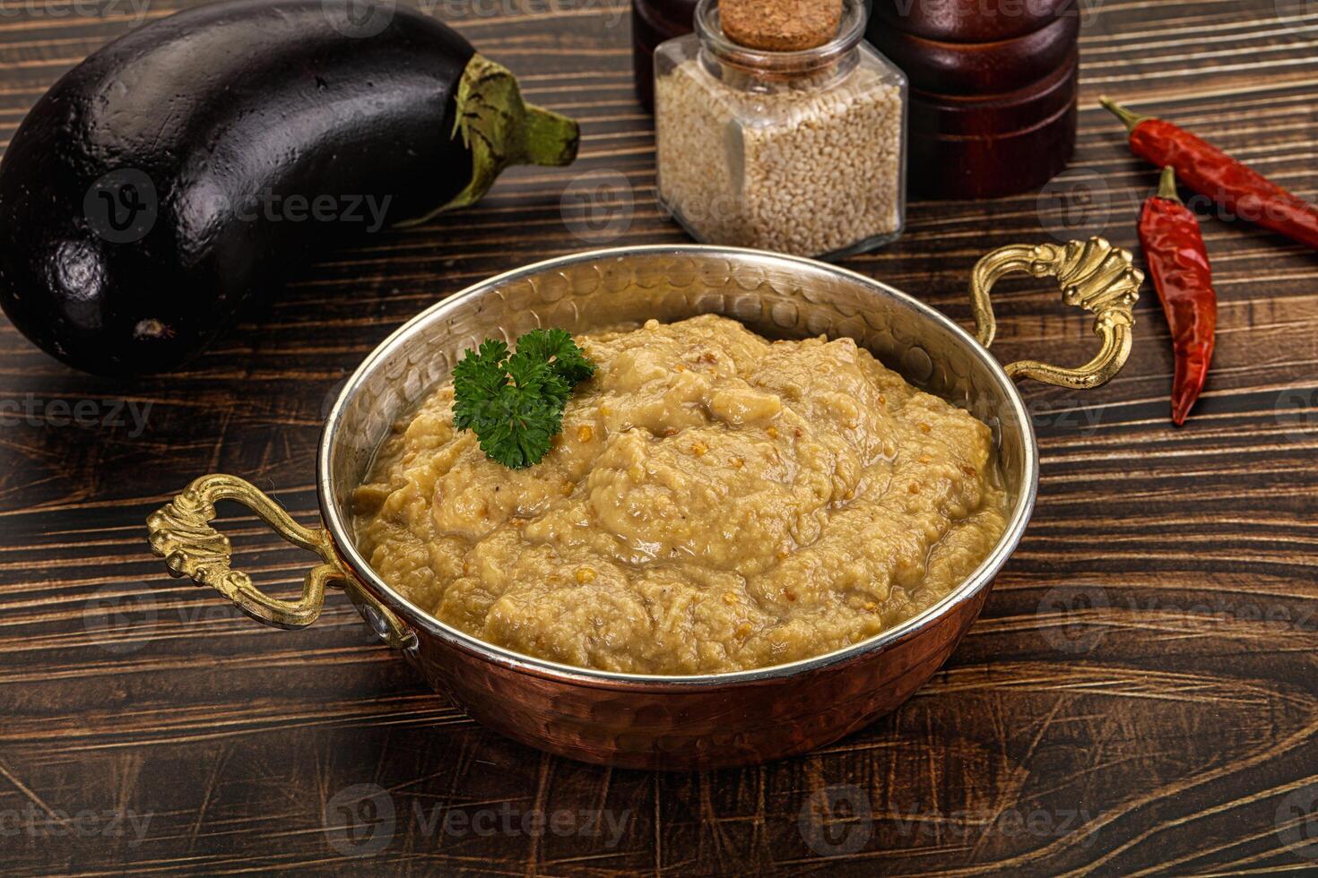 A bowl of food on a table next to a bowl of spices photo