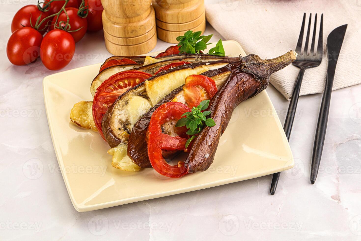 A plate with a steak, vegetables and a knife and fork photo
