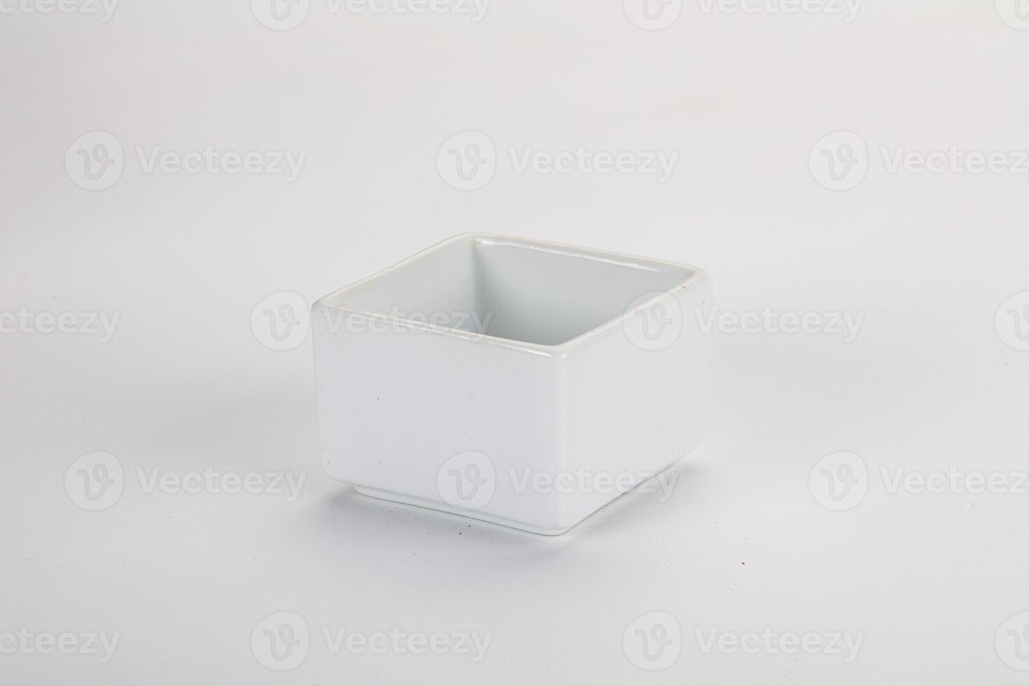 A white square container with a lid on a white surface photo