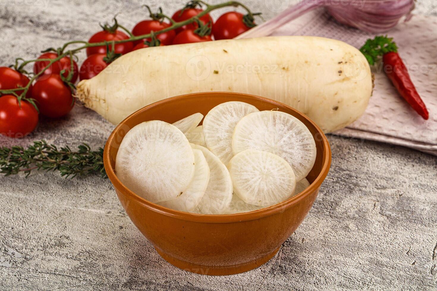 A bowl of white potatoes and tomatoes on a table photo