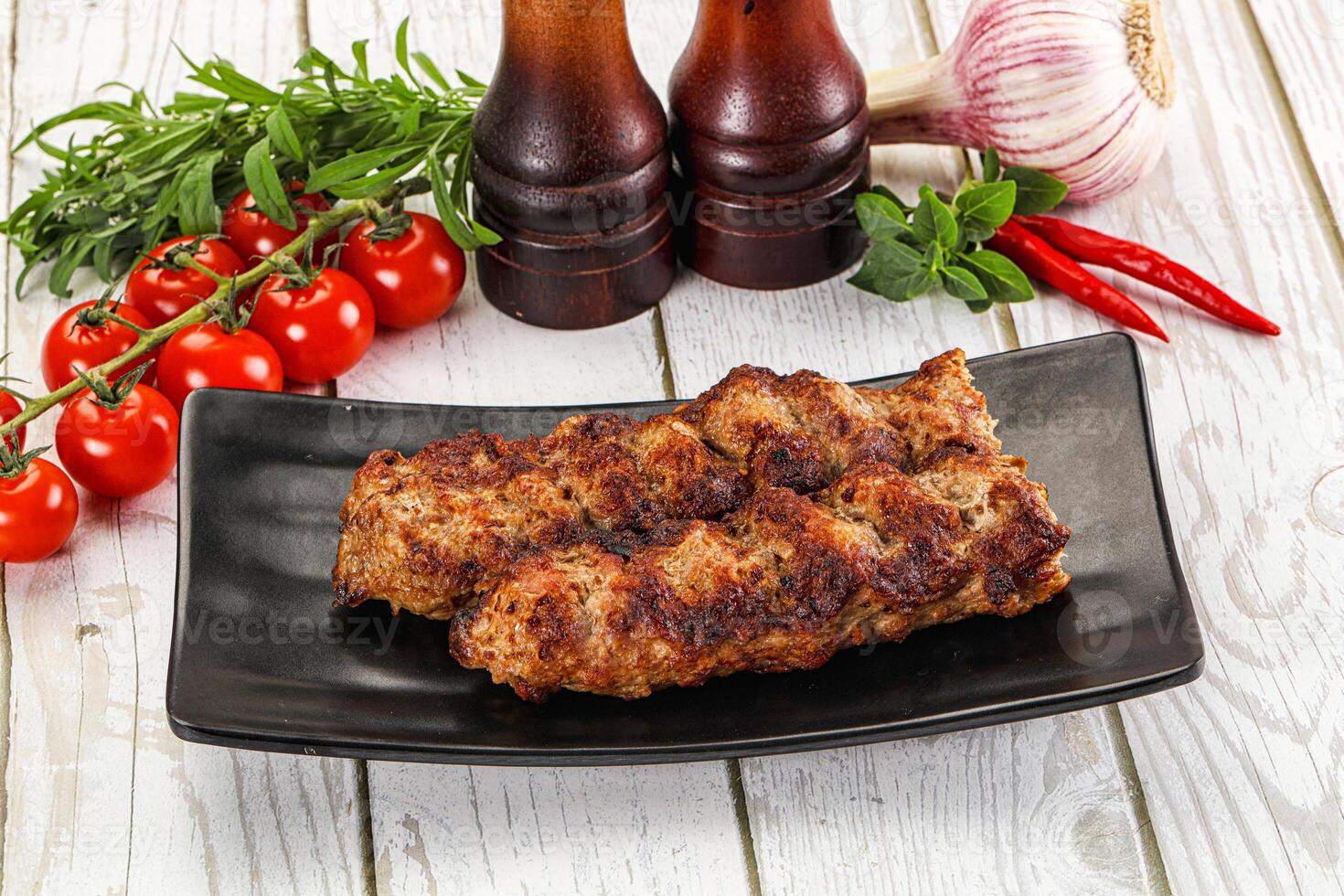 A plate with meat and vegetables on it photo