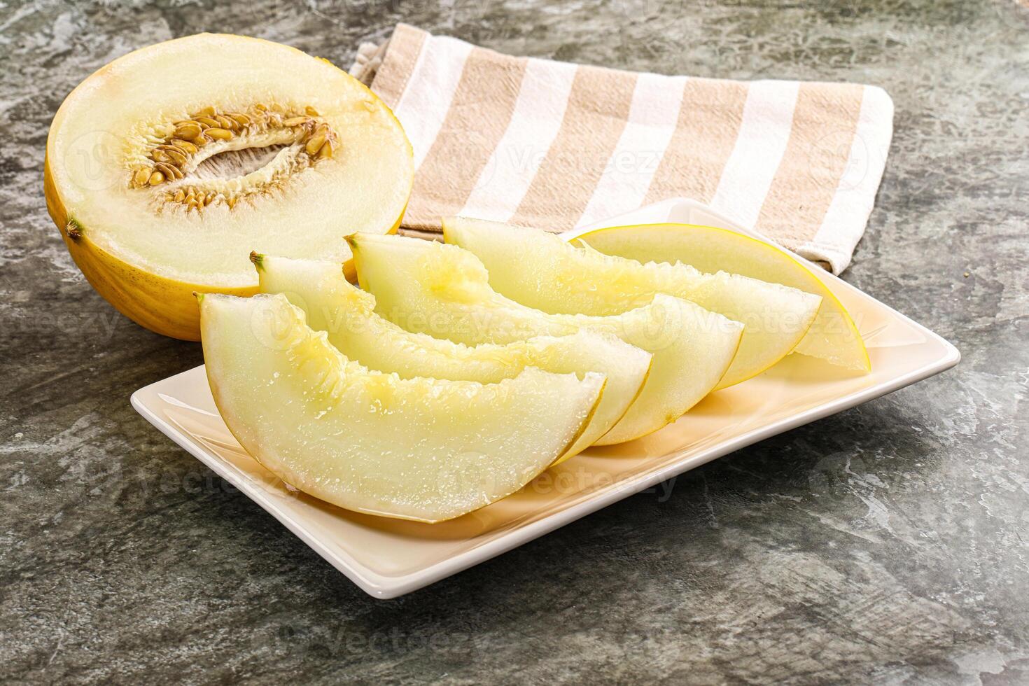 A white plate with a slice of melon on it photo