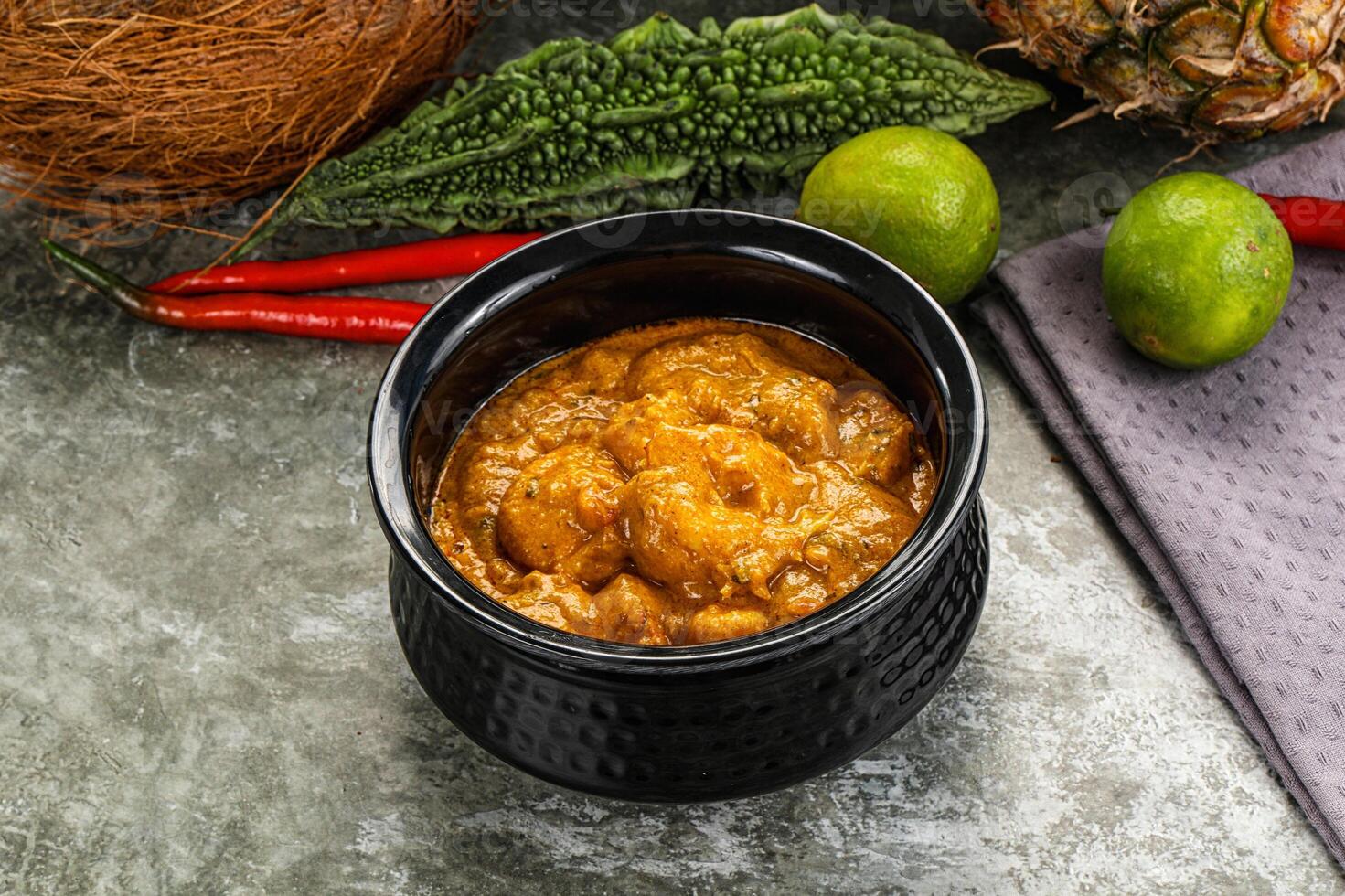 A bowl of curry with a pineapple and other ingredients photo