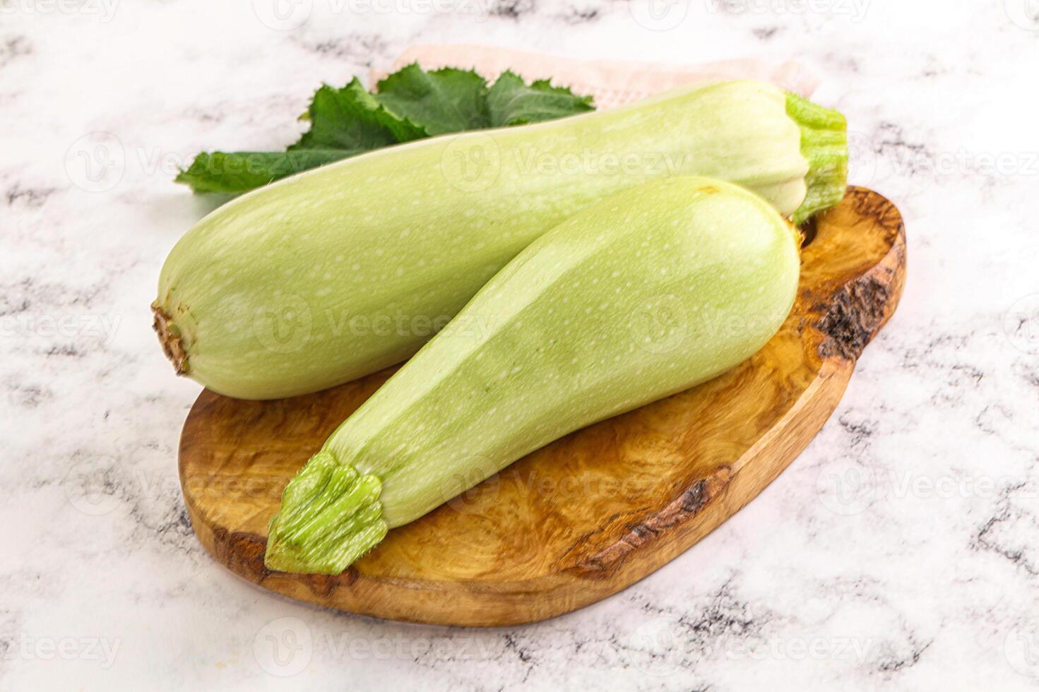 Two zucchini on a wooden cutting board photo
