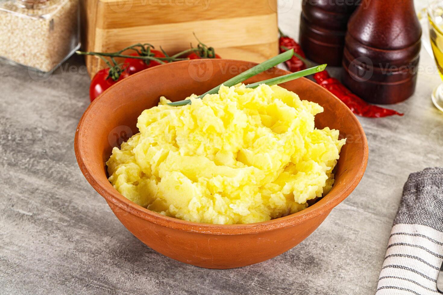 A bowl of mashed potatoes with a green sprig photo