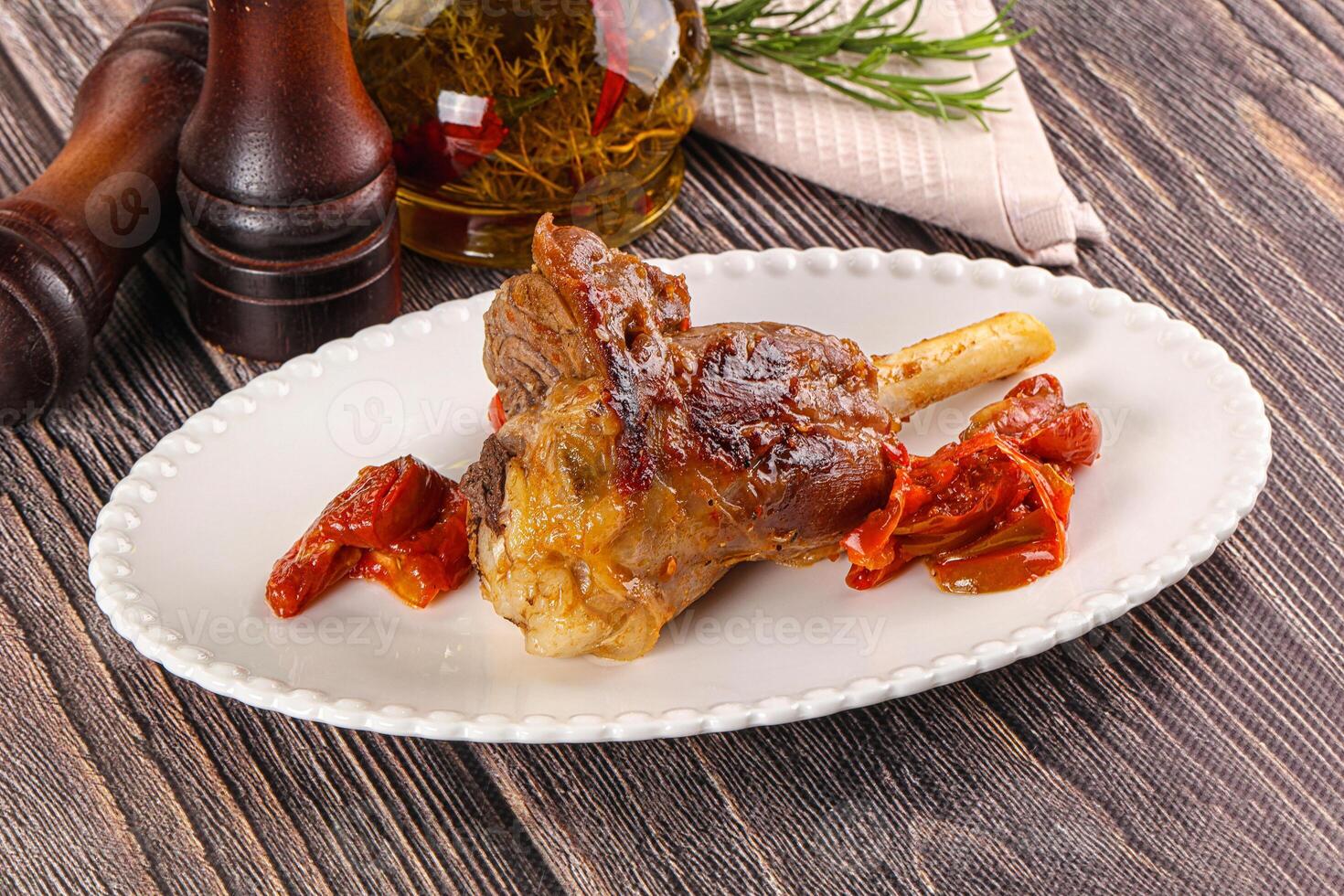 A plate of meat on a wooden table photo