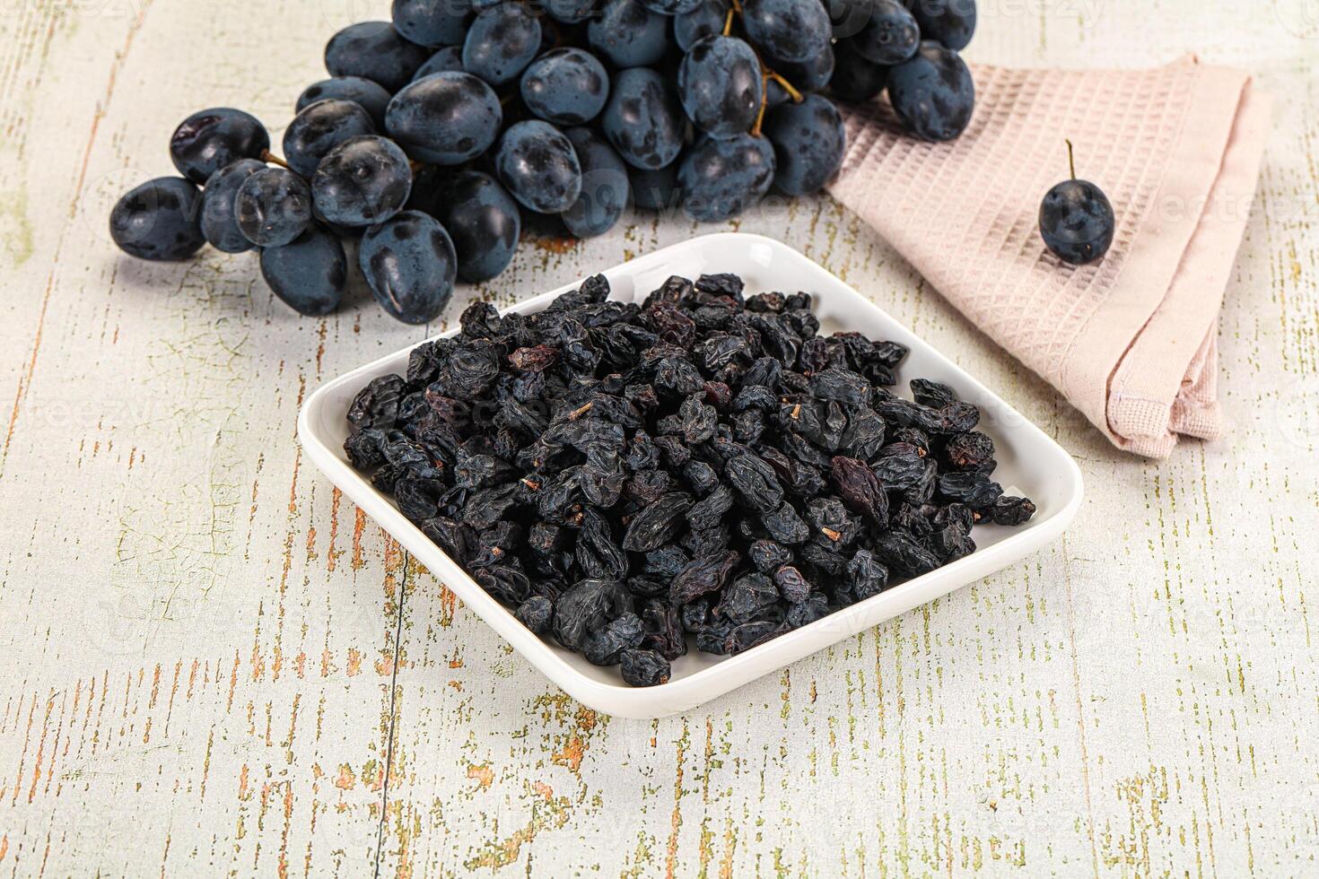 A bowl of black grapes photo