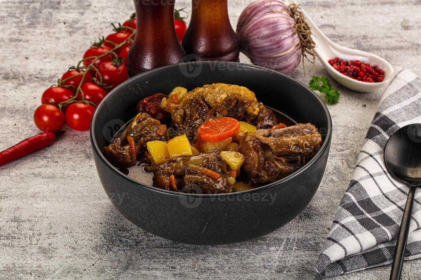 A bowl of stew with vegetables and meat in it photo
