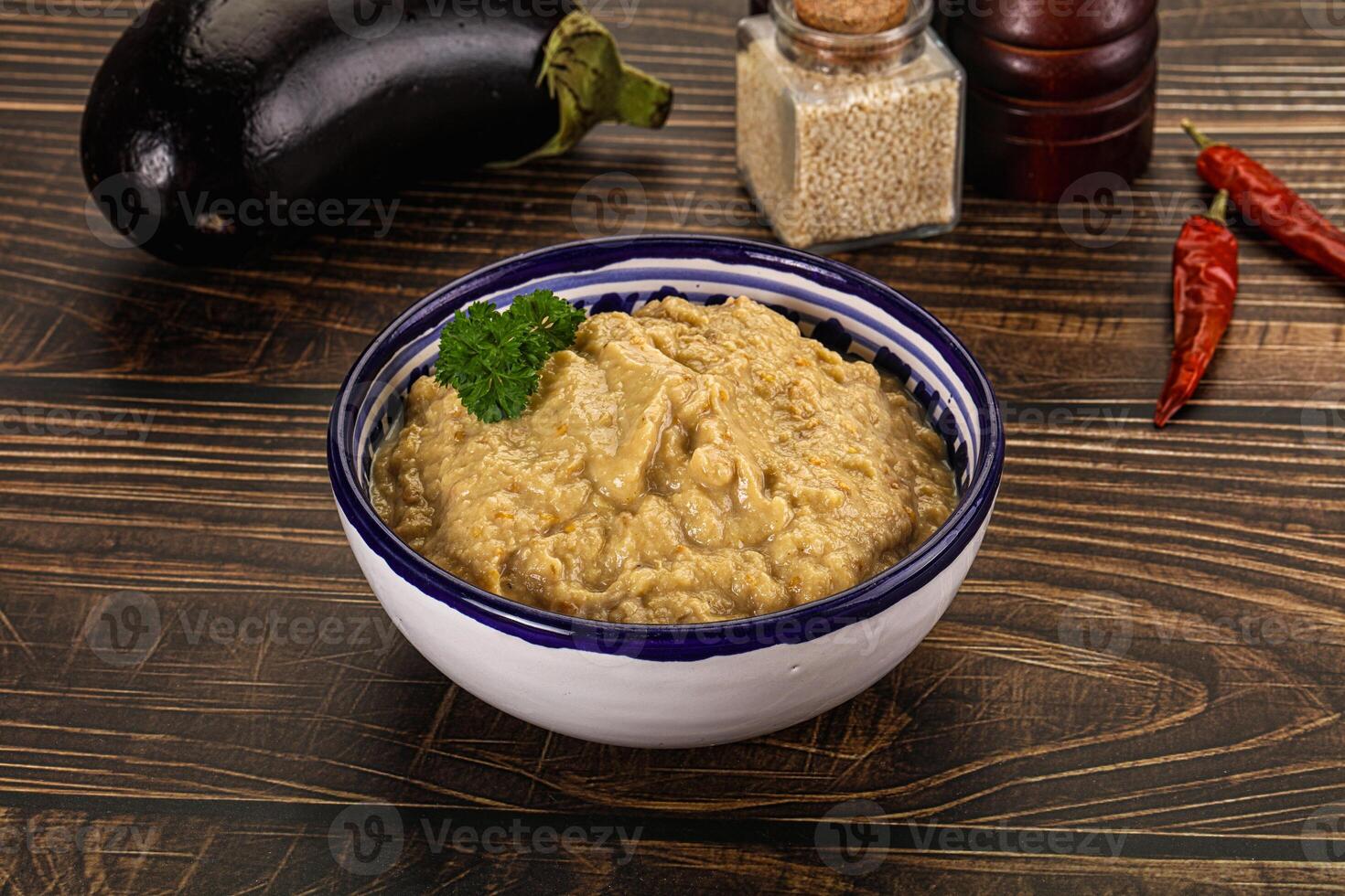 A bowl of eggplant dip on a table photo