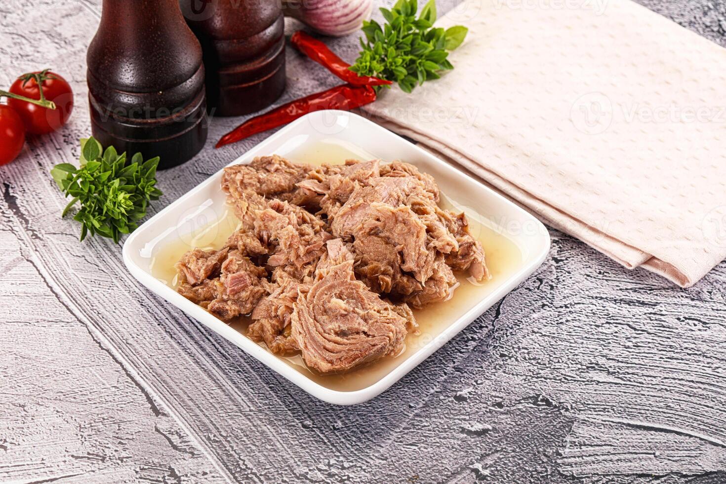 A bowl of meat and vegetables on a table photo