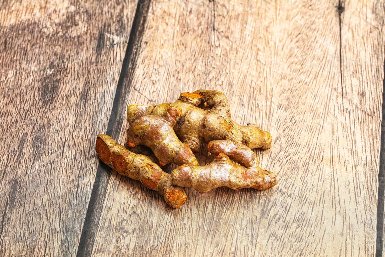 A pile of ginger on a wooden table photo