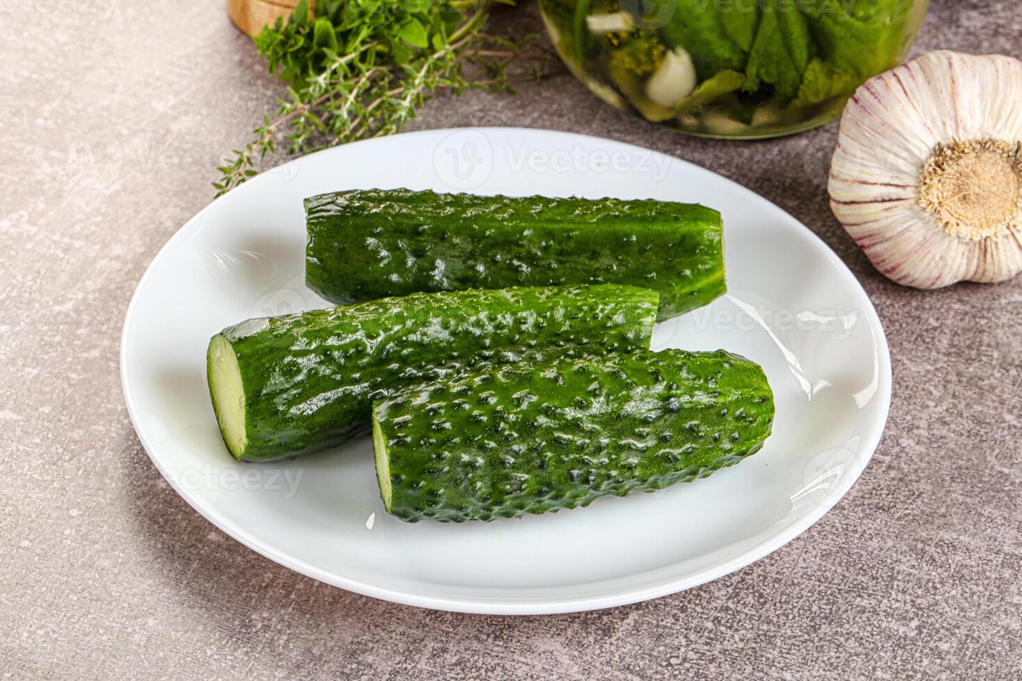 A white plate topped with cucumbers and garlic photo