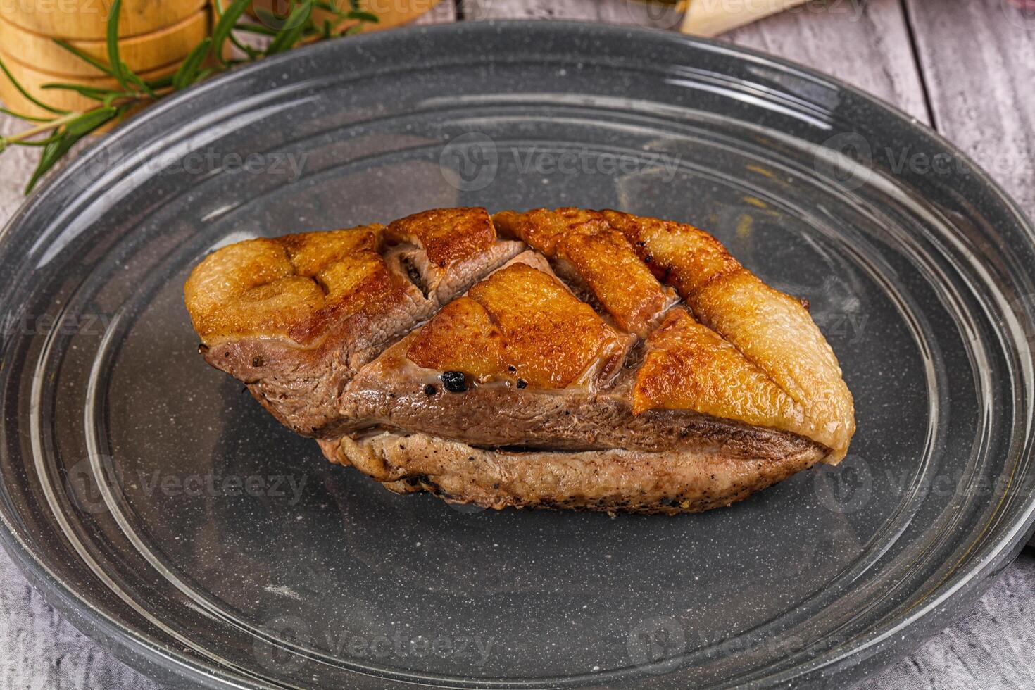 A piece of meat on a plate with a knife photo