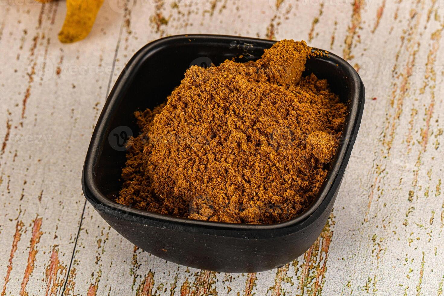 A bowl of spices on a table photo