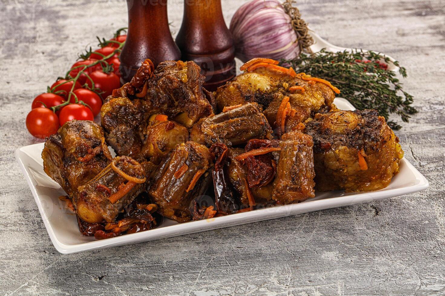 A plate of meat and vegetables on a table photo