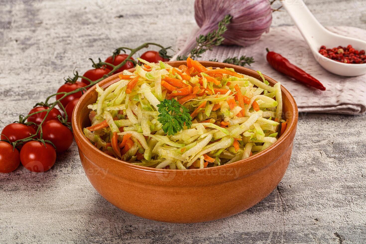 A bowl of coleslaw with carrots and tomatoes photo