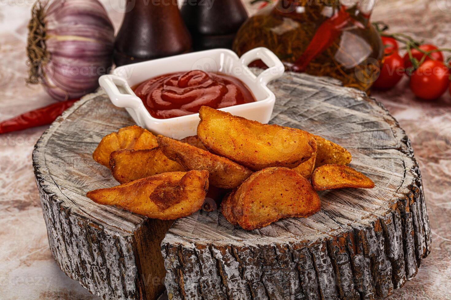 A plate with some potatoes and ketchup photo