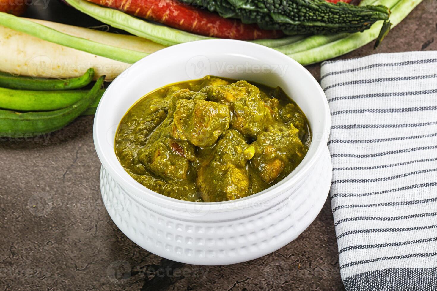 A bowl of food with vegetables and a towel photo
