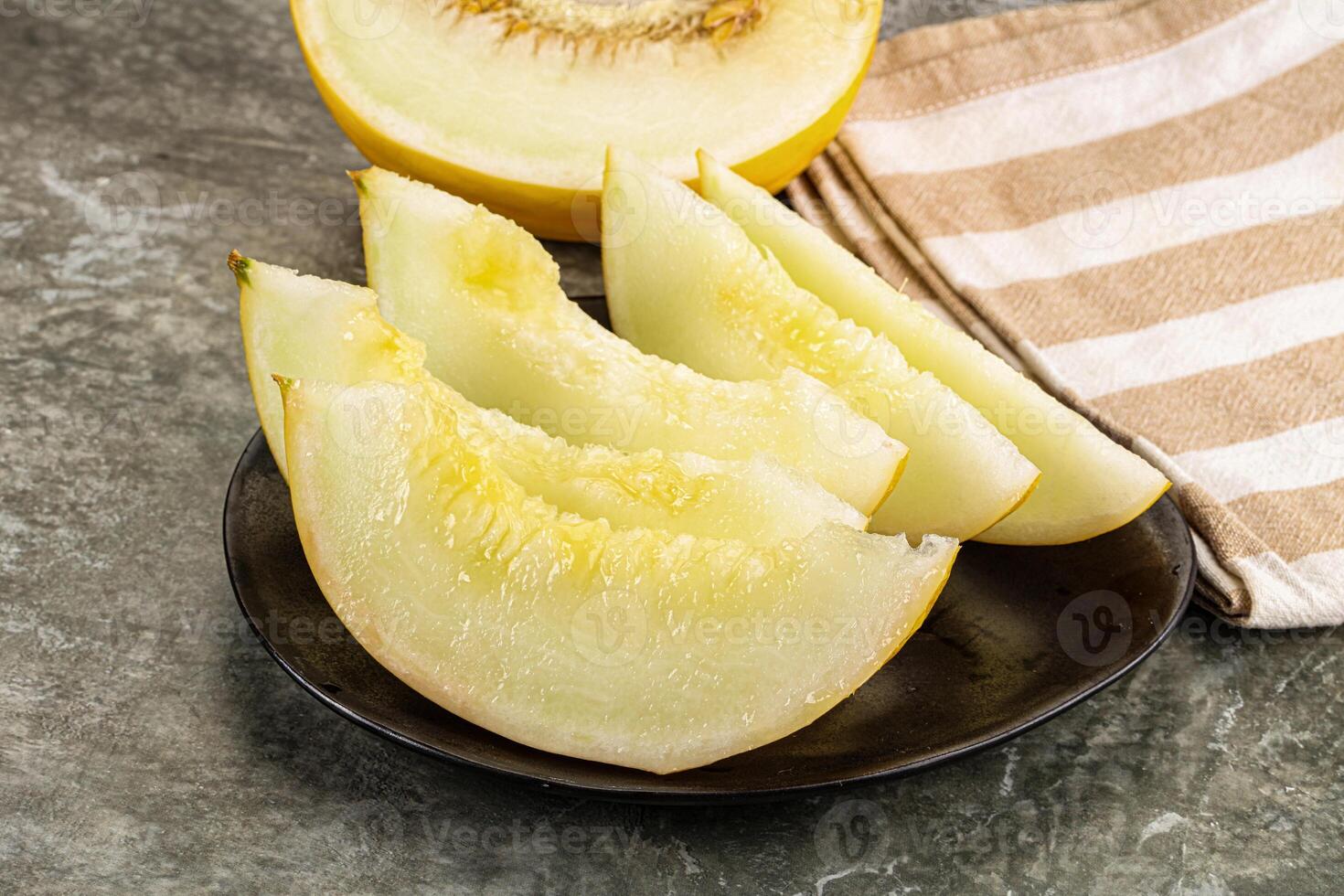 A plate with sliced melon on it photo