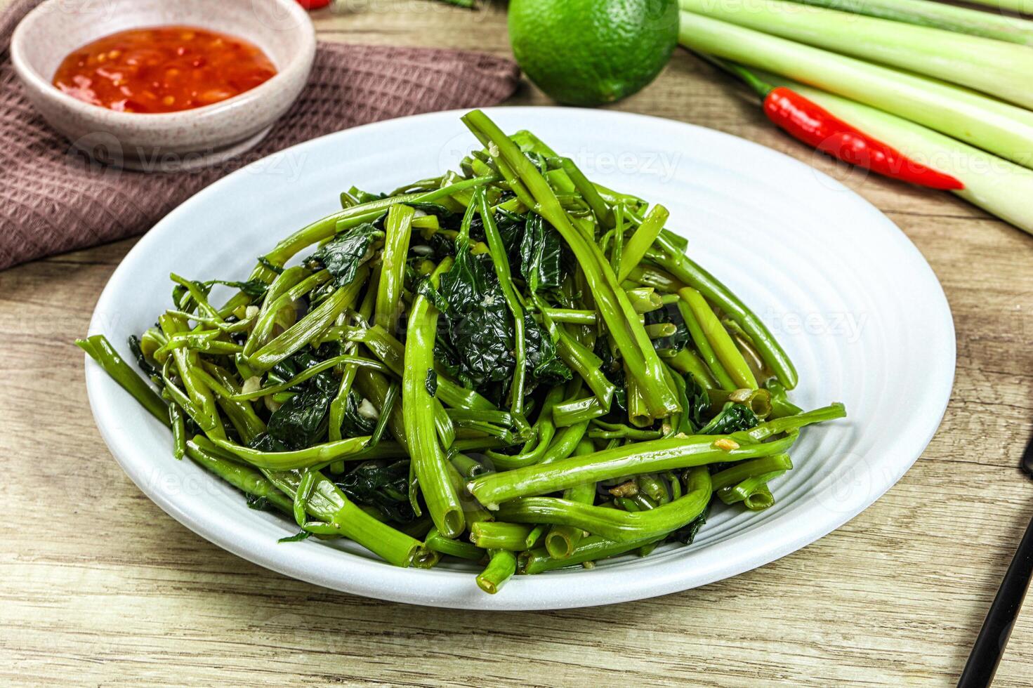 A white bowl of green beans and a knife photo
