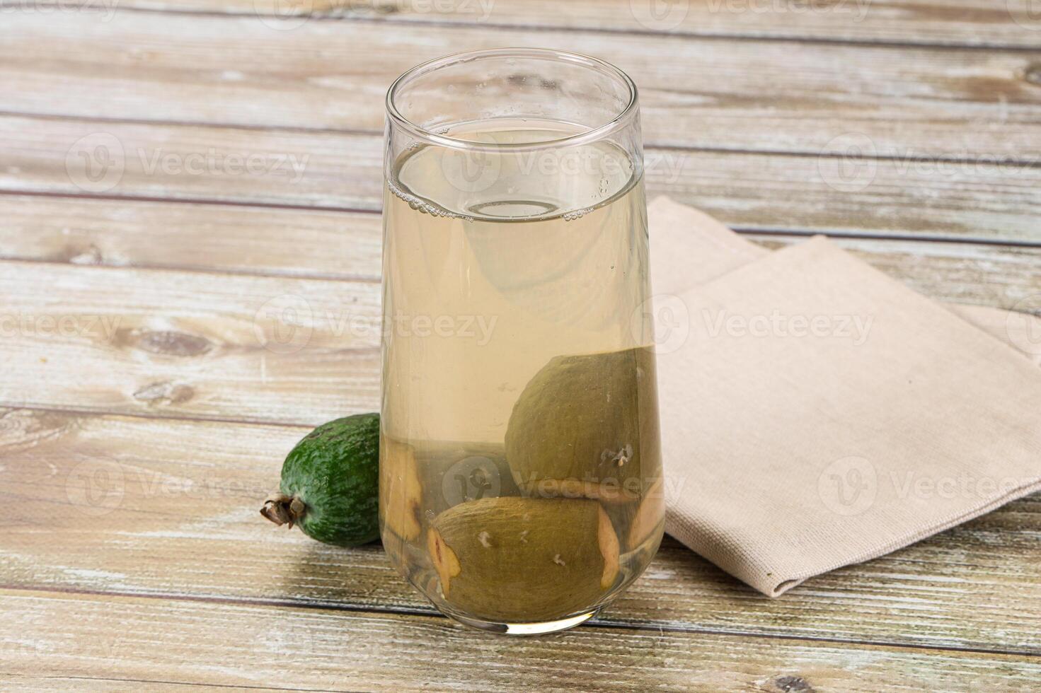A glass of water with a lemon and lime in it photo
