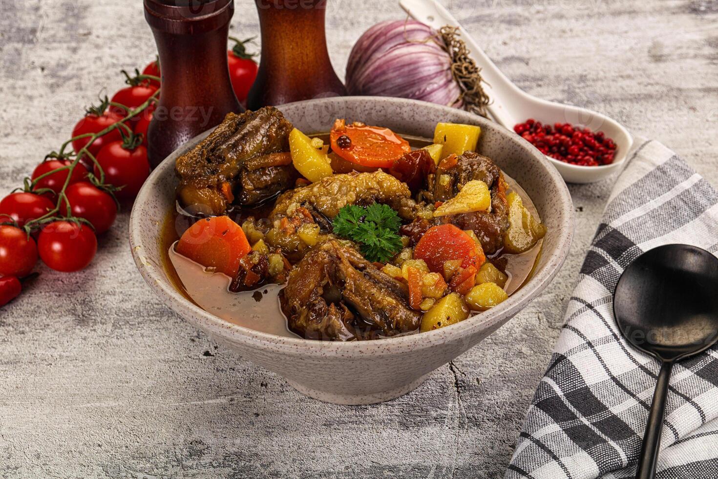 A bowl of stew with vegetables and meat in it photo