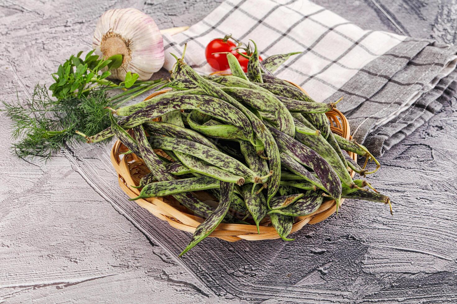A basket of green beans on a table photo